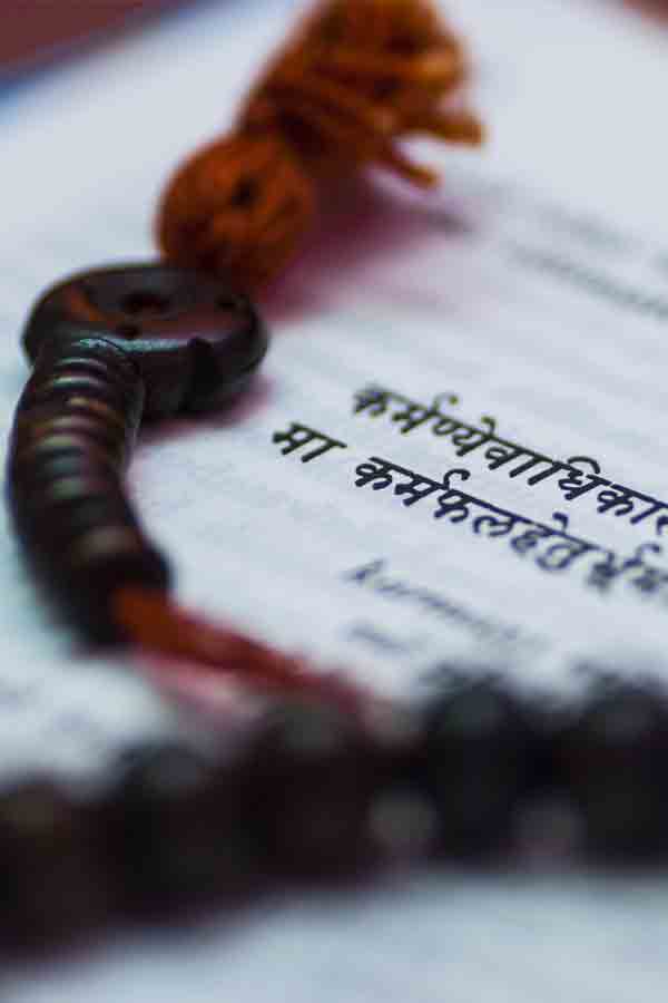 Guru Bead Sanskrit words on a book