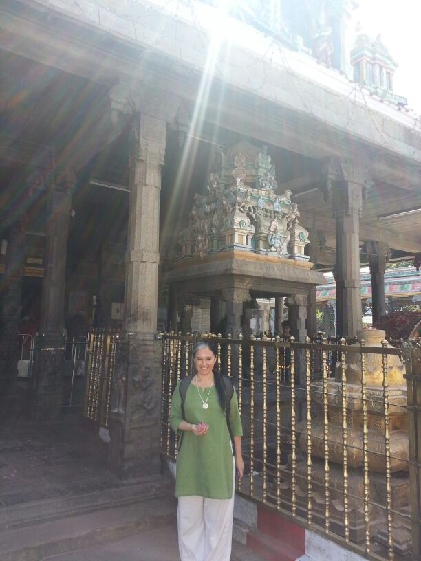 Woman in green dress in an Indian temple