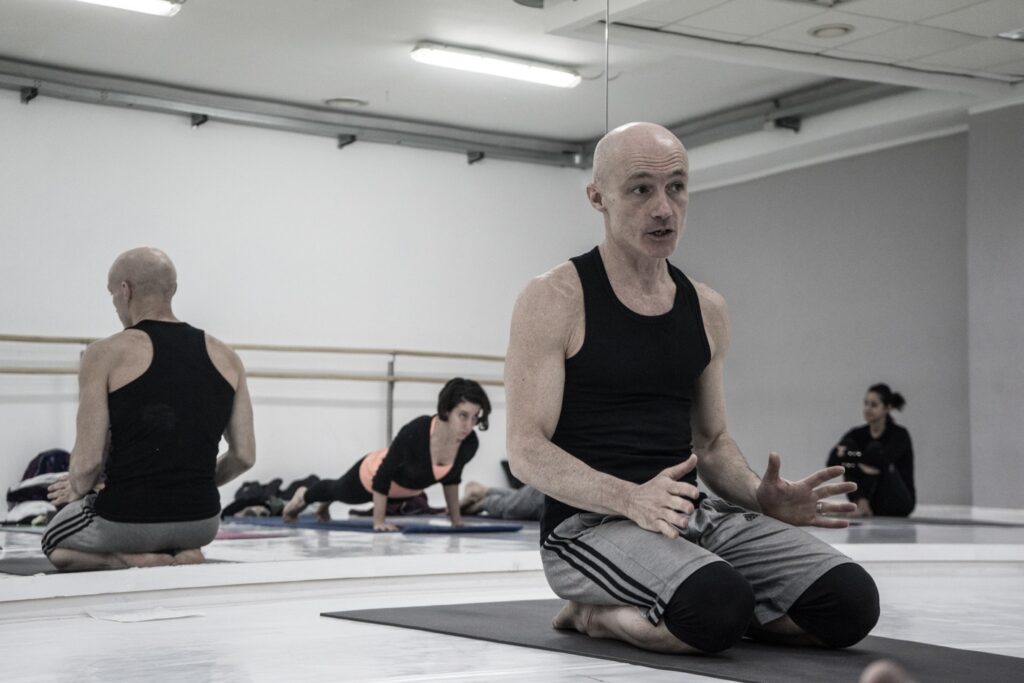 Daniele Morganti's Ashtanga workshop in Barcelona, November 2023, sitting on a yoga mat.