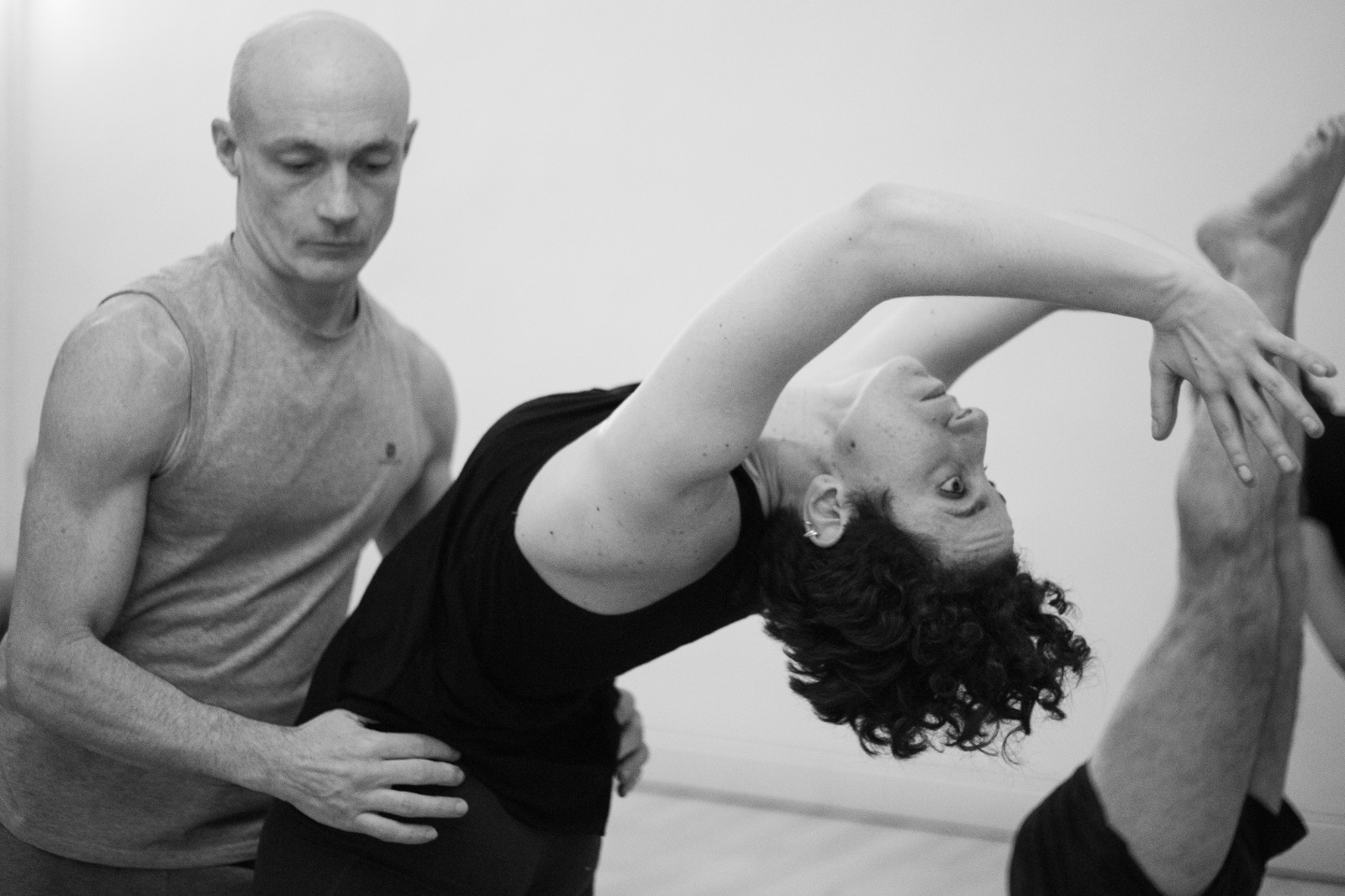 A couple engaging in yoga during Daniele Morganti's Ashtanga workshop in Barcelona, November 2023, captured in a black and white photo.